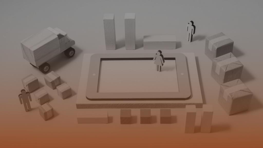 Whissel Strategies Wooden figures, boxes, and a truck are arranged around and on top of a large tablet, suggesting a concept of logistics or supply chain management with digital integration—perfect for a Toronto Marketing Agency like Whissel Strategies. Toronto Digital Marketing Agency